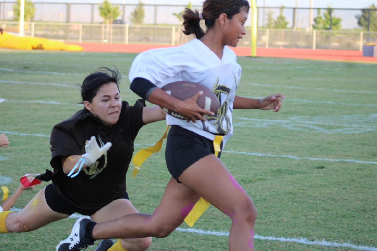 Miley Hernandez Moreno (left) dives for Mariana Lopezs flags Friday afternoon during Del Oros first-ever powder puff football game .