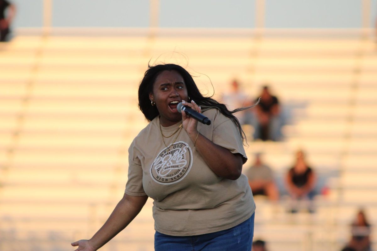 ASB president Jalynn Hammond hypes up the home crowd prior to the start of the varsity game.