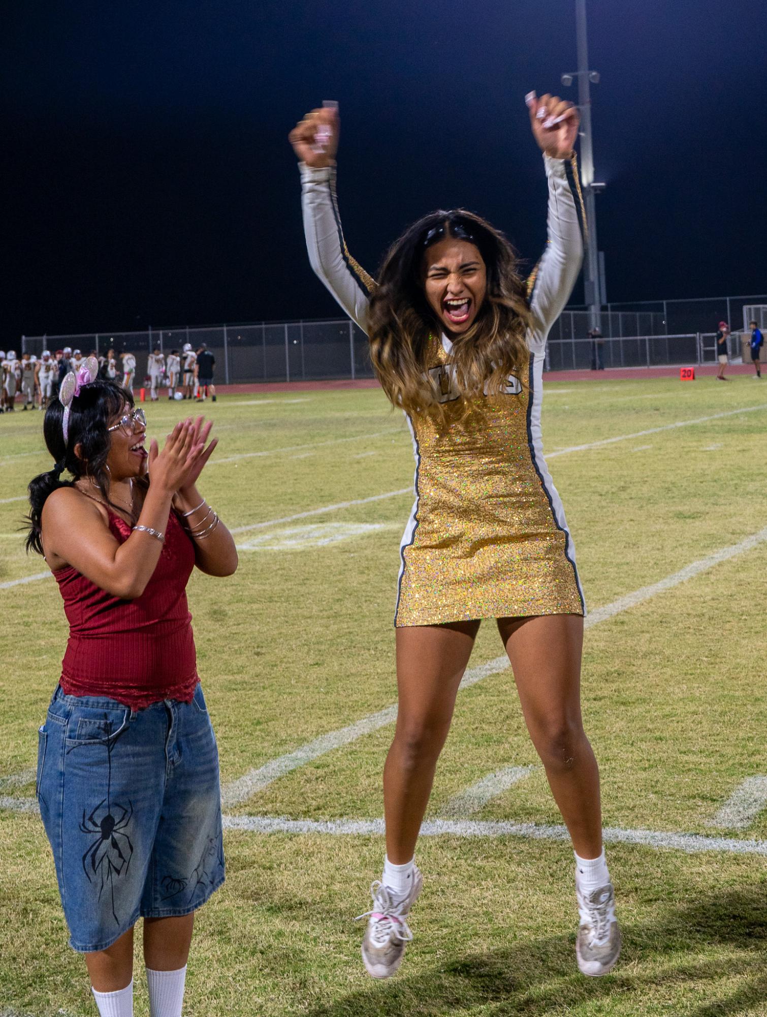 Senior cheerleader Ashley Guerrero (right) reacts after being named Del Oro's second-ever Homecoming queen during halftime of Friday's game against Mira Monte.