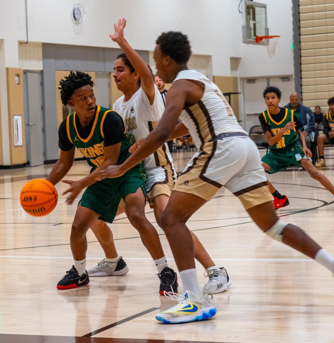 Isreal Amaya(center) and Keenan Starling defend against a Vikings player during Monday's 79-33 win at home.