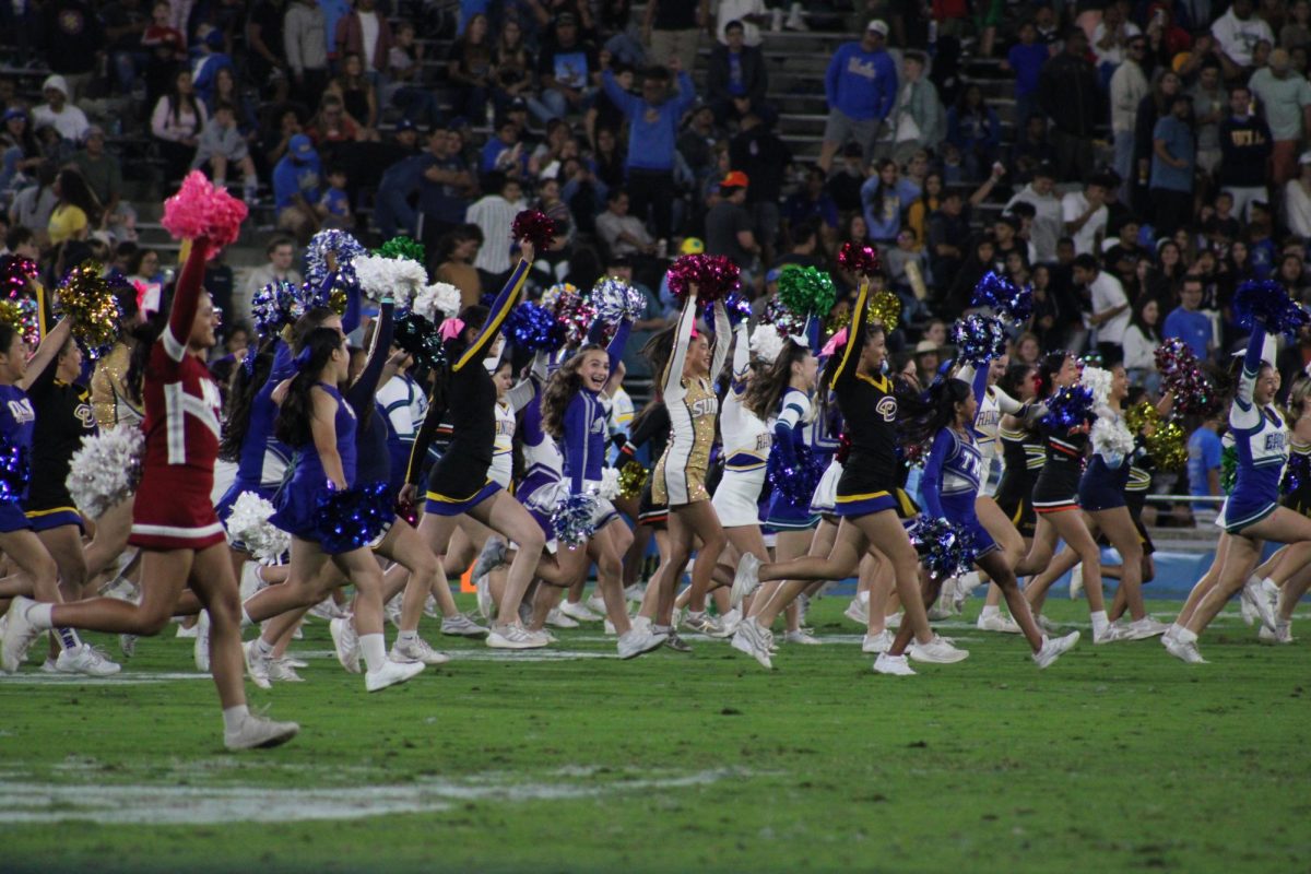 Sophomore Khloe Soto (center) was among more than 500 high school and middle school cheerleaders who took the field at halftime during UCLA’s home game against Minnesota on Oct. 12.