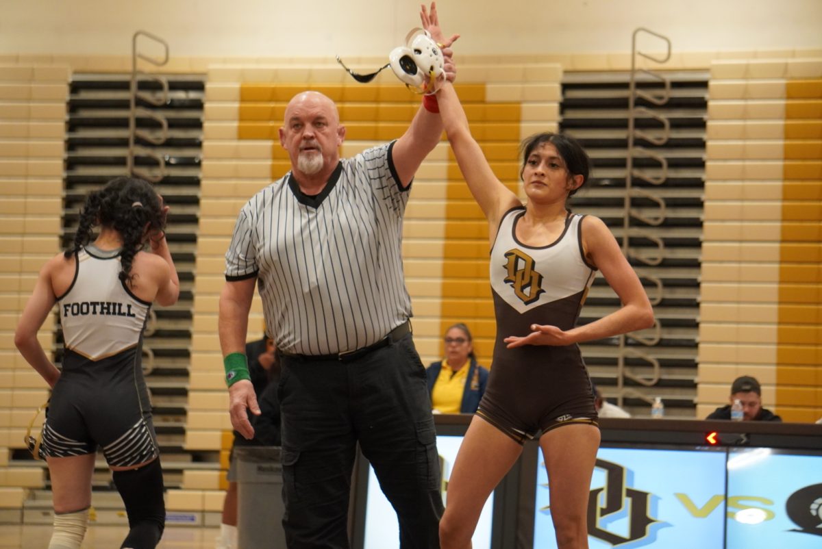 Senior Maria Mejia has her hand raised in victory after her match on Thursday.