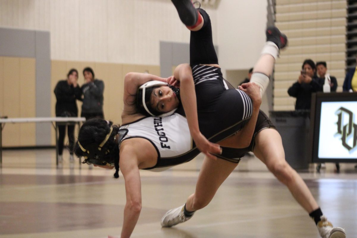 Senior Maria Mejia slams her opponent.