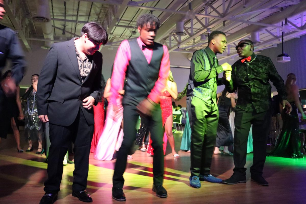 (L to R) Michael McCleary, Ernest Jones IV, Keenan Starling, and Tyzouri Turner heat up the dance floor during last year's "Great Gatsby"-themed winter formal in the cafeteria. This year's event will be at the Bakersfield Music Hall of Fame, making it Del Oro's first off-campus dance.