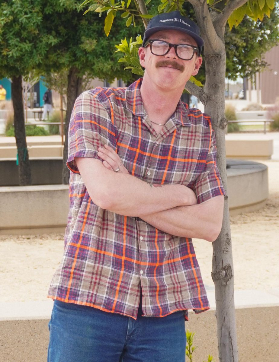Plaid button-down shirts have never gone out of style for Librarian Isaac Richert.