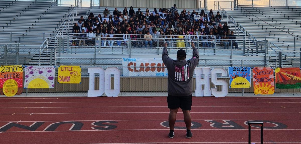 Del Oro’s Activities Director Desmond Ramey (foreground) reminds the members of the Class of 2025 to smile during their Senior Sunrise group shot on Sept. 20, 2024. There were plenty of reasons to smile this school year for the first-ever graduating class of Suns, whether it was from a senior-specific event like Grad Bash or a final trip to the campus library.