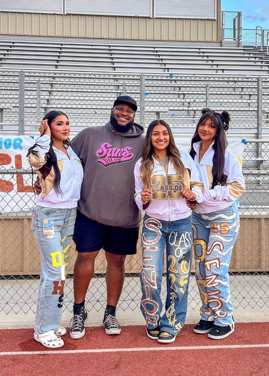 Ashley Mendez, Ashley Guerrero and Vanessa Hurtado pose with cheer coach Desmond Ramey during Senior Sunrise.