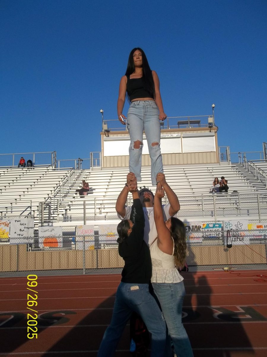 During Friday's Senior Sunrise, cheerleader Zitlalis Vela was held up by teammates Jason Jimenez, Yuridia Muro (right) and junior Jaritza Frias.