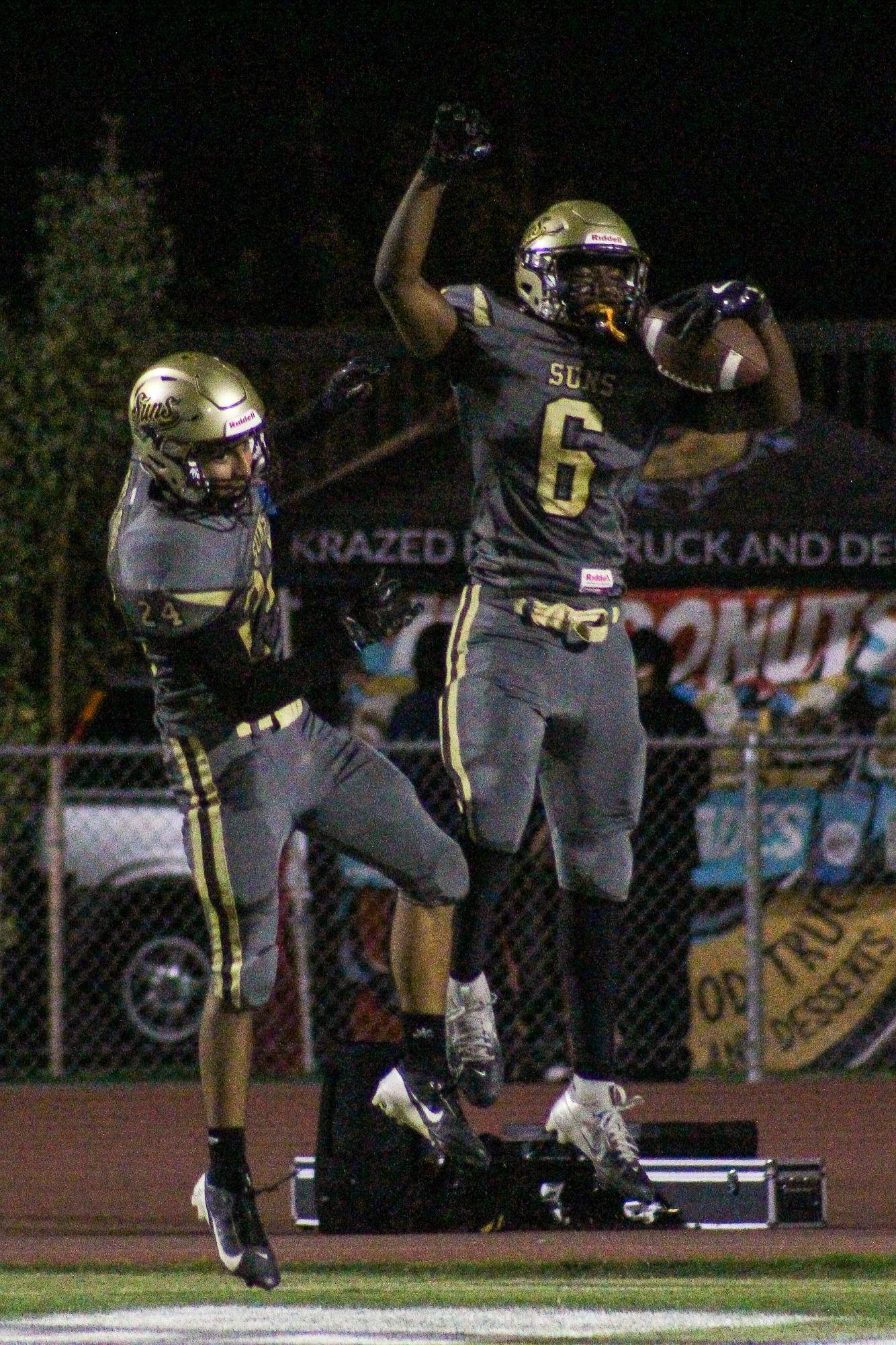 Dareon Sterling (right) and Adrian Gracian celebrate after a touchdown during Friday's win over Santa Maria.