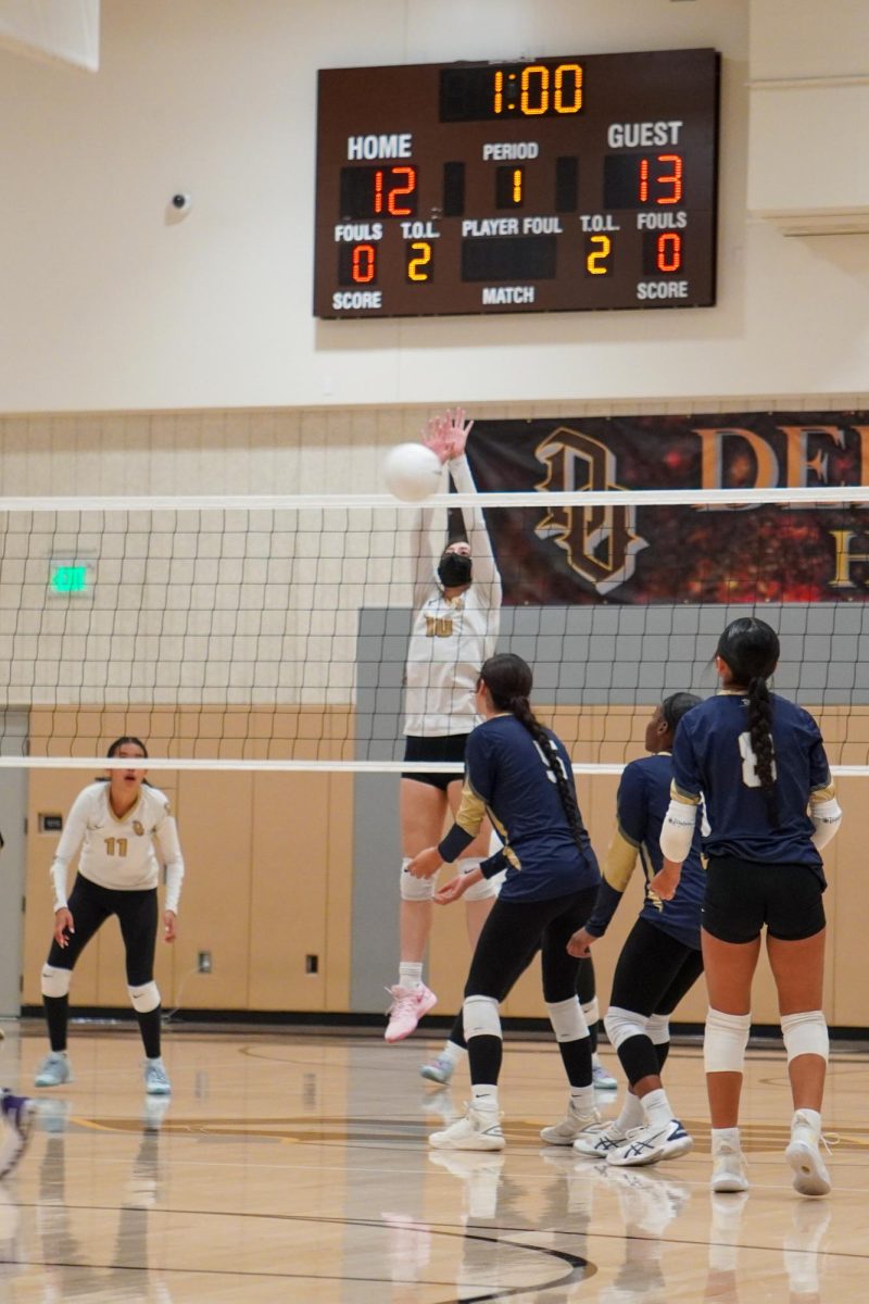 Senior Marisol Ponce (center) blocks the ball during Wednesday's match.