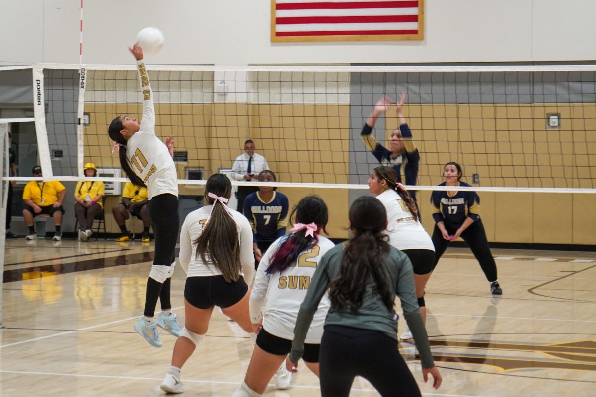 Viviana Vasquez (left) spikes the ball against Golden Valley.
