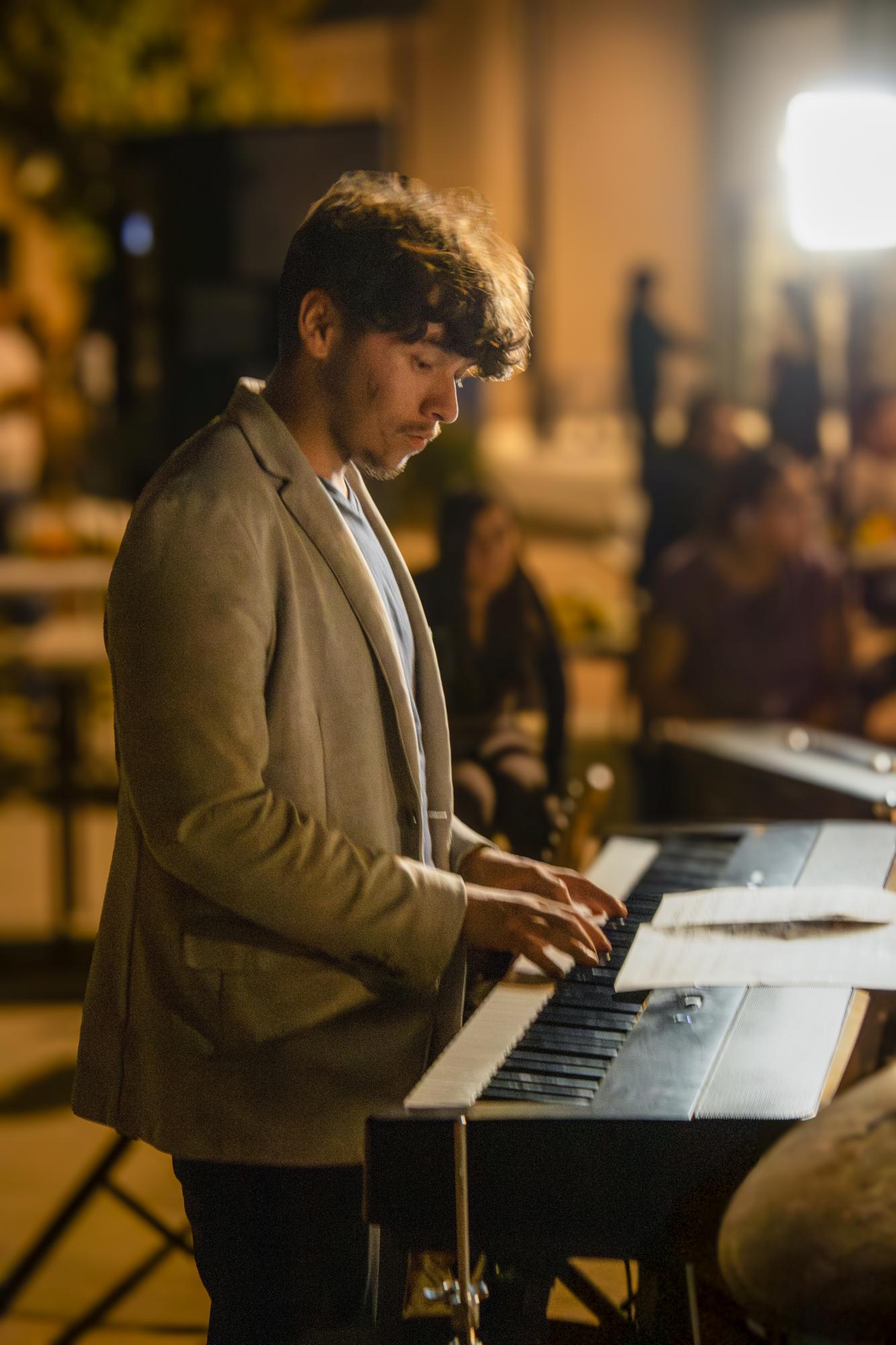 Senior Timothy Espinosa plays the keyboards during the Jazz band's performance on Thursday during the Ecos de Pasado carnival.