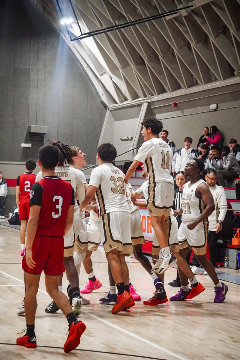 Del Oro's varsity boys basketball team celebrates its 54-52 victory on Wednesday over Division I opponent Sanger West at the Lloyd Williams Shootout at North High.