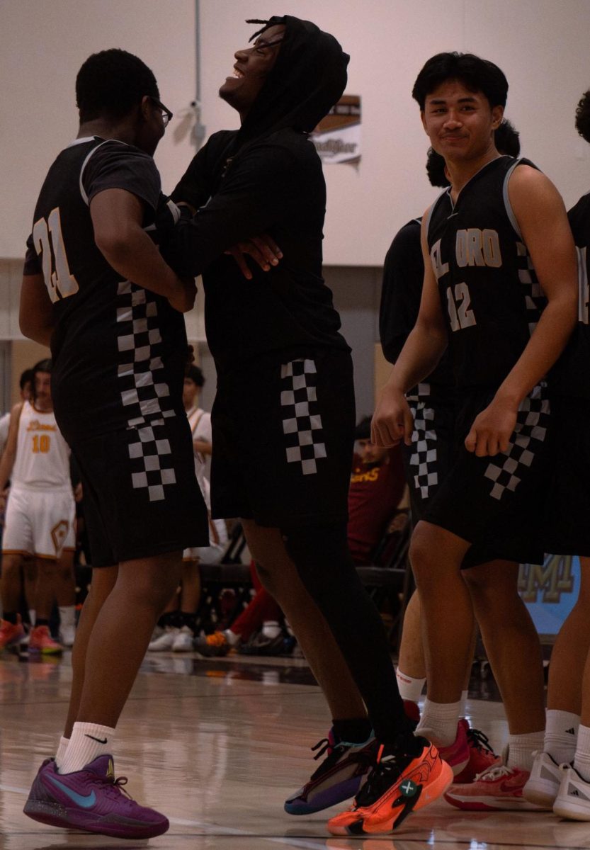 Jordan Thompson (far left) and Ernest Jones IV bump into one another in celebration, while teammate Ivan Jaime smiles after the Suns' 74–58 win over Mira Monte on Feb. 3.