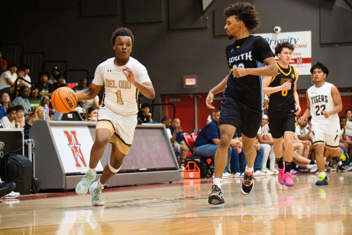 Suns senior Keenan Starling driving toward the basket while South High's Clifford Willis tries to defend.