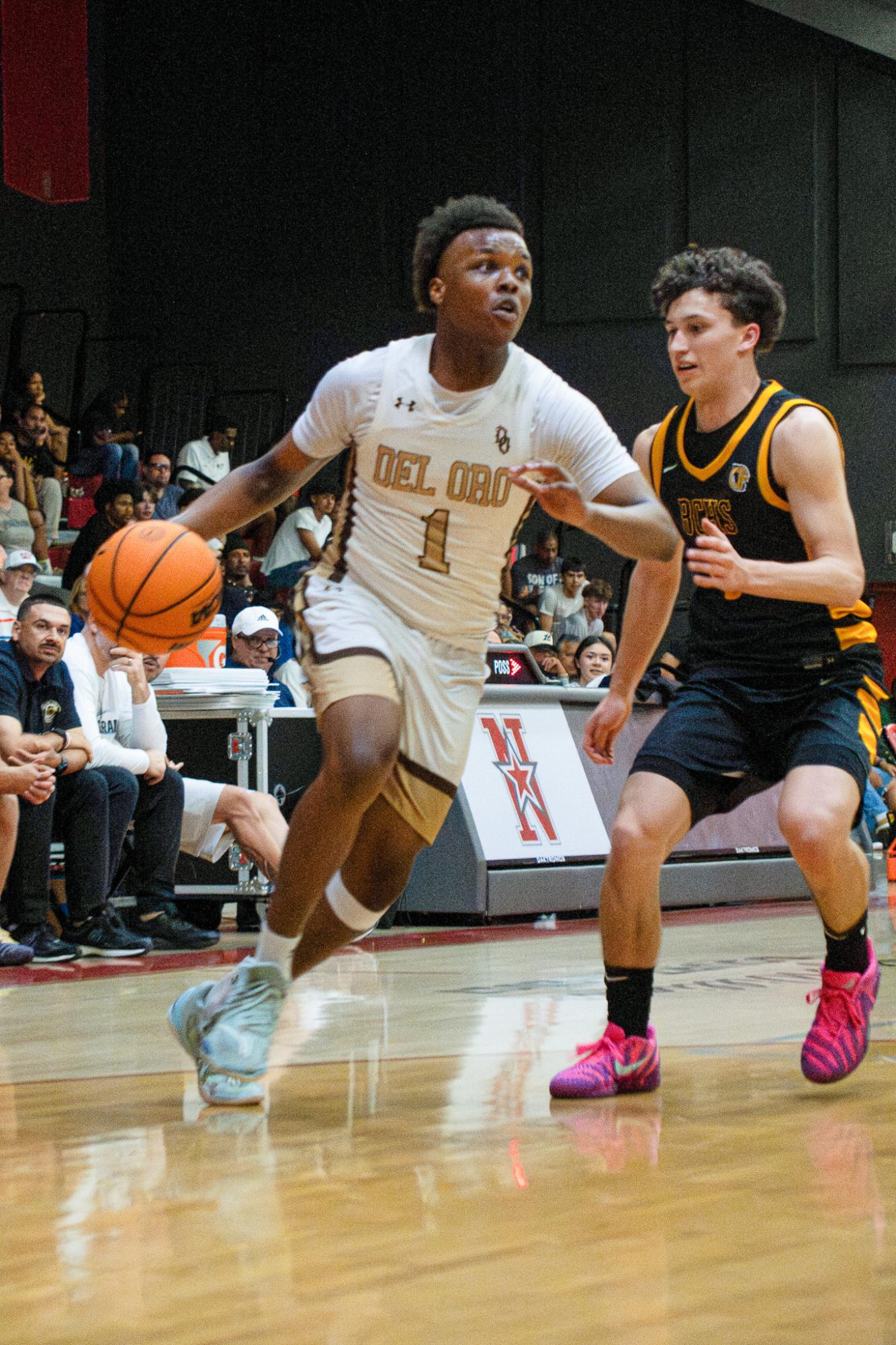 Del Oro point guard Keenan Starling drives toward the basket while Jeffrey Smith from Bakersfield Christian High School tries to defend him during last Wednesday's Kern High School District All-Star basketball game at North High.