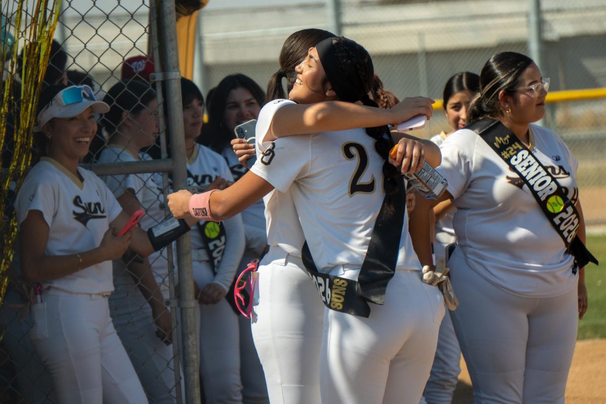 Yuliana Barajas and Davina Garcia share a hug during a pregame ceremony honoring the team's seniors.