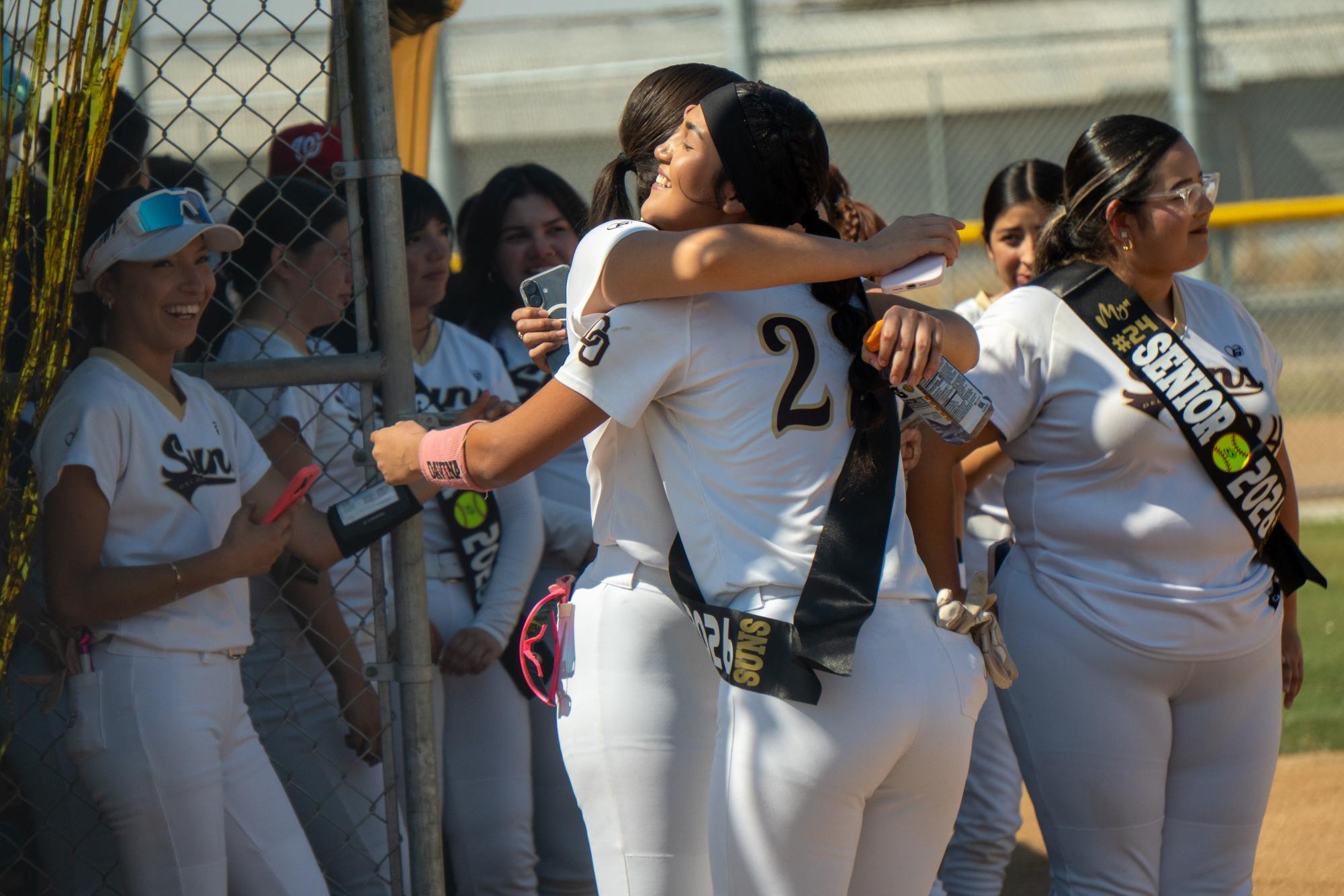 Yuliana Barajas and Davina Garcia share a hug during a pregame ceremony honoring the team's seniors.